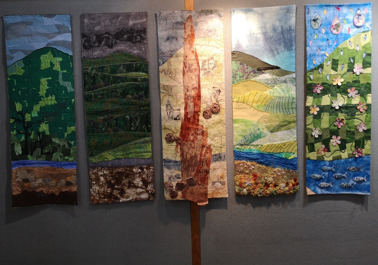 Hills and Rivers' is a joint work by the 5 members of the Ecostitchers textile art group. This piece takes its inspiration from the landscape of our city. Each panel is designed separately by one of the members, drawing on their particular skills and their feelings about the landscape.